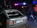 Rescuers work near a damaged car at the site of an Israeli airstrike that targeted a building in the town of Aramoun, south of Beirut on March 4, 2026.