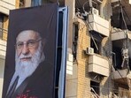 A banner of Iran�s supreme leader Ayatollah Ali?Khamenei is seen next to a building damaged by an Israeli strike in the southern suburbs of Beirut on March?3,?2026. The war launched by the United States and Israel against Iran spread across the Middle East, threatening to plunge the global economy into chaos, with Lebanon and Gulf energy exporters dragged into the conflict. (Photo by AFP)