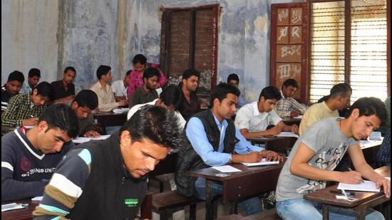 Students write an exam at the DAV (PG) College in Dehradun on Thursday. (Kuldeep Rana/HT Photo)