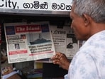 A man checks the local newspaper, following a submarine attack on the Iranian military ship, IRIS Dena, off the coast of Sri Lanka.