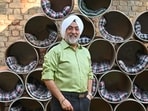 Jagjit Singh standing next to the shelters made from drums. (Parveen Kumar/HT)