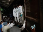 Healthcare workers unload from a vehicle, the bodies of Iranian sailors who died when their IRIS Dena warship sank outside Sri Lanka's territorial waters.