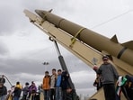 Boys stand on a launcher of an Iranian domestically-built missile during an annual rally Boys stand on a launcher of an Iranian domestically-built missile during an annual rally