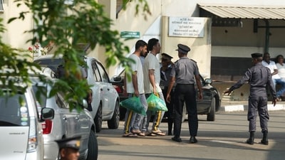 Two Iranian sailors, carrying green bags, who were rescued from IRIS Dena warship by Sri Lanka's navy are escorted to a Judicial Medical Officer.(Photo for representation) (AP)