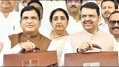 CM Devendra Fadnavis, Dy CM Sunetra Pawar and state finance minister Ashish jaiswal shows the budget bag before presenting it to state during the budget assembly session at Vidhan bhavan in Mumbai on Friday (Anshuman Poyrekar/HT Photo)