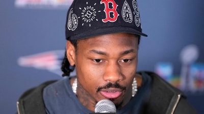 Stefon Diggs #8 of the New England Patriots addresses the media prior to Super Bowl LX (Getty Images via AFP)