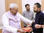 Bihar Chief Minister Nitish Kumar receiving 'Prasad' on his birthday by his son Nishant Kumar at his residence in Patna, Bihar, India, Sunday,01, 2026.