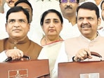 CM Devendra Fadnavis, Dy CM Sunetra Pawar and state finance minister Ashish jaiswal shows the budget bag before presenting it to state during the budget assembly session at Vidhan bhavan in Mumbai on Friday (Anshuman Poyrekar/HT Photo)