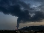 Fire and a plume of smoke is visible after, according to authorities, debris of an Iranian intercepted drone hit the Fujairah oil facility, in Fujairah, United Arab Emirates.