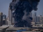 Dubai Abu Dhabi news: A black plume of smoke rises from a warehouse in the industrial area of Sharjah City following Iranian strikes in Dubai, United Arab Emirates.