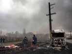 An Iranian civil defence member stands with a hose next to a destroyed fuel tanker vehicle near an ongoing fire following an overnight airstrike on the Shahran refinery in northwestern Tehran on March 8, 2026. Photo: AFP