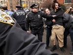 A left-wing activist is detained by police after throwing a homemade explosive device towards police during a protest organized by far-right influencer Jake Lang against alleged "Islamification" and to ask for a "stop of public Muslim prayer" in New York, in front of Gracie Mansion, New York mayor Zohran Mamdani's official residence, in New York on March 7, 2026. (Photo by CHARLY TRIBALLEAU / AFP)