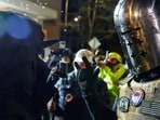 A counter-protester wearing a medieval helmet faces off against a protester who gathered during a vigil, after a U.S. immigration agent shot and killed 37-year-old Renee Nicole Good in her car in Minneapolis, outside the Portland ICE facility in Portland, Oregon, U.S., January 10, 2026.  REUTERS/John Rudoff
