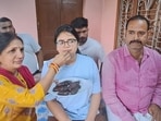 Mother offering sweets to Akanksha Singh, who claimed to have cracked the UPSC, at her home in the Katira locality of Ara, Bihar, India, Friday,06, 2026.