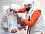 Haryana Chief Minister Nayab Singh Saini takes blessings from Satguru Uday Singh, in Sirsa on Sunday. (ANI) Haryana Chief Minister Nayab Singh Saini takes blessings from Satguru Uday Singh, in Sirsa on Sunday. (ANI)
