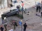 Israeli security forces inspect an area damaged during an airstrike in Tel Aviv, Israel, Sunday, March 8, 2026.