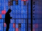 A man stands in front of an electronic quotation board displaying the Nikkei 225 stock prices on the Tokyo Stock Exchange in Tokyo.