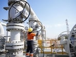 A worker operates valves at the Rumaila oil field in Basra, Iraq, to cut nearly 1.5 million barrels per day of output as exports halted due to the effective closure of the Strait of Hormuz amid the Iran war.