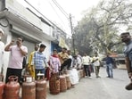 People stand in a long queue to collect LPG cylinders at an Indane gas agency on Vala Kadar Road in Lalbagh, Lucknow, on Tuesday, after the government’s restriction on commercial gas supply triggered fears of a shortage. (Deepak Gupta/HT)
