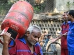 A delivery staff unloads liquefied petroleum gas (LPG) cylinders from a truck at a distribution point in Mumbai. A delivery staff unloads liquefied petroleum gas (LPG) cylinders from a truck at a distribution point in Mumbai.