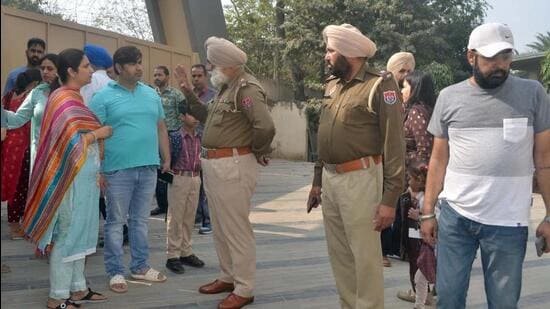 Police assuring anxious parents outside a school in Ludhiana after it received a bomb threat on Tuesday morning. (Gurpreet Singh/HT)