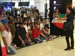 Supporters of the Iranian women's football team gather at Sydney Airport, after some of its players were granted asylum.