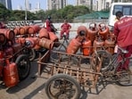 Workers load LPG cylinders in a cart, in Mumbai, Wednesday, March 11, 2026. 