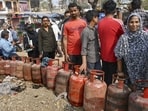 People queue up to book LPG cylinders at a gas agency in Prayagraj on Wednesday. (PTI Photo)