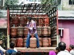 A worker unloads an LPG cylinder from a truck at a distribution center amid reported disruptions in commercial LPG supply due to escalating tensions in West Asia
