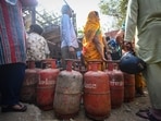 People stand in long queues to get the refilled LPG cylinder outside a gas agency near Karol Bagh in New Delhi