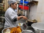 Ashwini Kadam, 31, who prepares snacks at the restaurant, said cooking on induction stoves requires thrice the time compared to LPG stoves (Raju Shinde/ HT Photo)