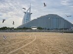 Dubai Abu Dhabi news live:  Seagulls fly over the beach with the Burj Al Arab and Jumeirah Marsa Al Arab hotels in the background in Dubai, United Arab Emirates, Thursday, March 12, 2026.