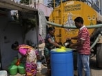 Residents of Ambedkar Nagar, a low-income settlement in the shadows of global software companies in Whitefield neighborhood, collect potable water from a private tanker in Bengaluru, India, Monday, March 11, 2024. Water levels are running desperately low, particularly in poorer regions, resulting in sky-high costs for water and a quickly dwindling supply. (AP Photo/Aijaz Rahi) (AP)
