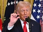 Donald Trump gestures as he speaks during a Women's Month History event in the East Room of the White House