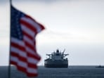 FILE: A US flag flutters in the wind as the CHIOS crude oil tanker sits anchored off the coast of the Chevron's El Segundo Refinery in El Segundo, California. 