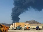 Smoke rises in the Fujairah oil industry zone, caused by debris after interception of a drone by air defenses. 