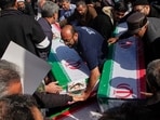 Mourners carry coffins during a funeral for people killed during the ongoing US–Israeli military campaign in Isfahan, Iran.