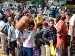People wait in queues amid LPG crisis at a gas agency in New Delhi, Friday, March 13, 2026. 