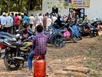 People queue up for cylinders on Friday in Bengaluru. (PTI)