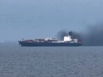 Smoke emerging from a cargo vessel, as filmed from another vessel, just north of Dubai.
