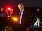 US President Donald Trump gestures after disembarking Air Force One at Palm Beach International Airport in West Palm Beach, Florida.