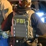 The FBI said 11 Indians have been charged in connection with staged armed robberies. 