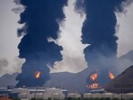 Plumes of smoke and fire rise after debris from an intercepted Iranian drone struck an oil facility, according to authorities, in Fujairah, United Arab Emirates, Saturday, March 14, 2026.
