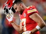 Kansas City Chiefs tight end Travis Kelce takes off his helmet during warmups before an NFL football game against the Denver Broncos
