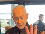 Israeli Prime Minister Benjamin Netanyahu shows his hand as he speaks at a cafe, amid the U.S.-Israeli conflict with Iran, in Jerusalem, March 15.