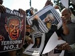 Shia Muslims burn posters of Israeli Prime Minister Benjamin Netanyahu and US President Donald Trump during an anti-US-Israel protest after Friday prayers in New Delhi.
