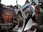 Shia Muslims burn posters of Israeli Prime Minister Benjamin Netanyahu and US President Donald Trump during an anti-US-Israel protest after Friday prayers in New Delhi.