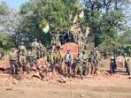 CRPF personnel stand atop the debris after demolishing a memorial built by Naxals in Sukma last month. (ANI)
