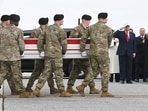 US President Donald Trump salutes as members of a US Army team carry the flagged-drapped transfer case containing the remains of US soldier Sgt. 1st Class Noah L. Tietjens during a dignified transfer solemn event at Dover Air Force Base, in Dover, Delaware.