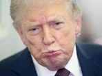 US President Donald Trump speaks with reporters aboard Air Force One during a flight from Florida to a military base in Maryland. He spent the weekend at his Mar-a-Lago resort. 